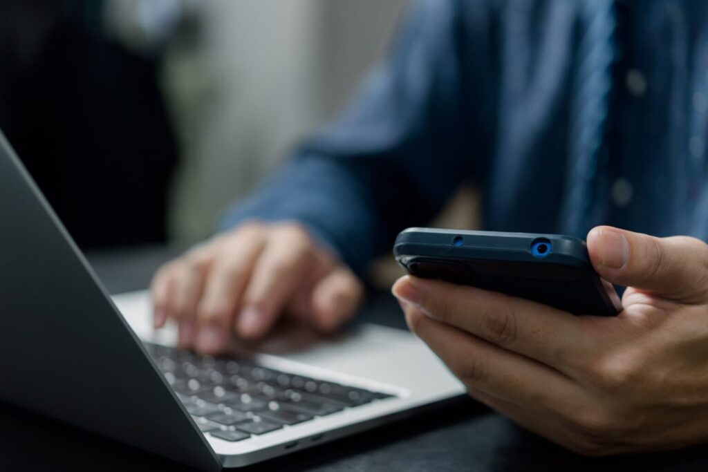 Digital forensics investigator identifying potential evidence across devices like laptops, smartphones, and cloud accounts.